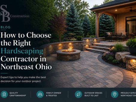 Luxury backyard hardscaping featuring a custom paver patio, retaining walls, fire pit, and covered outdoor living space designed by a professional hardscaping contractor in Northeast Ohio.