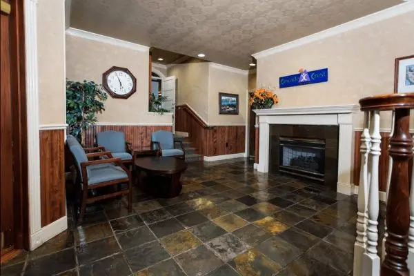 lobby with furniture fireplace clock and slate floor