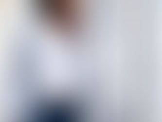 An African American woman, professional, look put together but feel stuck, staring into the space