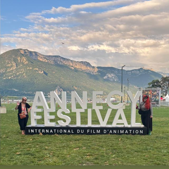 Me and my mum either side of the Annecy sign in front of the beautiful French/Swiss alps