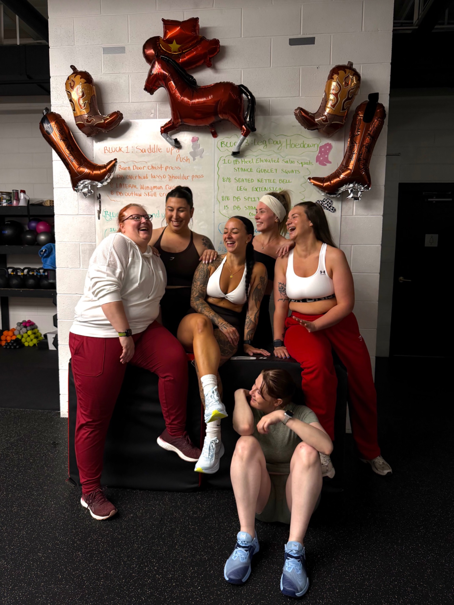 BFITNESS members laughing together at a themed group fitness event