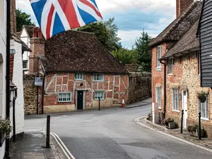 Traditional brick cottages on a British village street, illustrating the cost of sober living across the UK