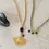Thumbnail: A Beautiful Story Empathy Necklace in Black Onyx + Gold available from Iris Lifestyle Cambridge UK