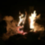 A glowing campfire scene at night.