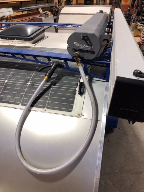 The Yakima Terrain Roadshower 4 with Spray nozzle, installed on the Pin Drop Travel Trailer Road Runner Model