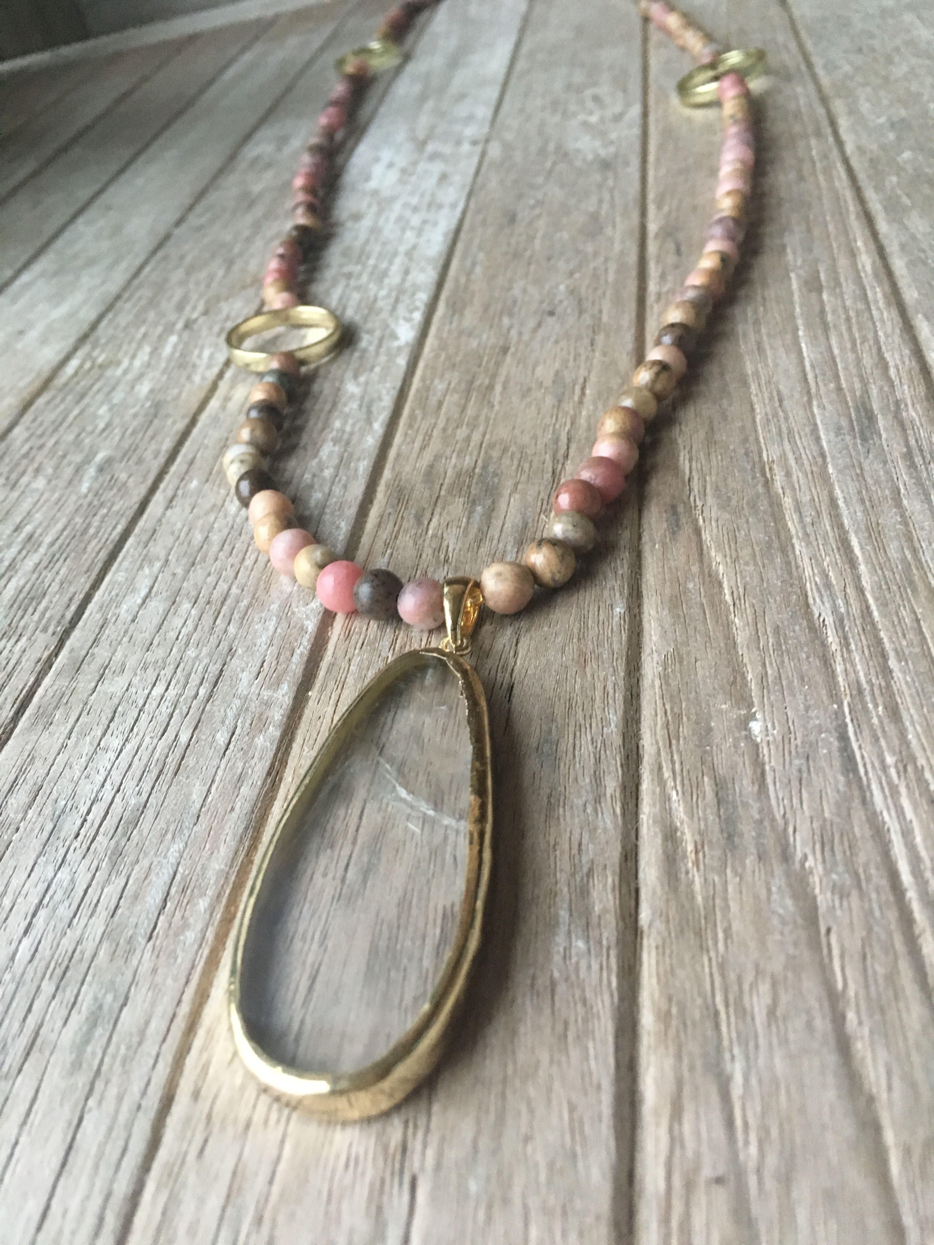 pink rock beads and clear stone