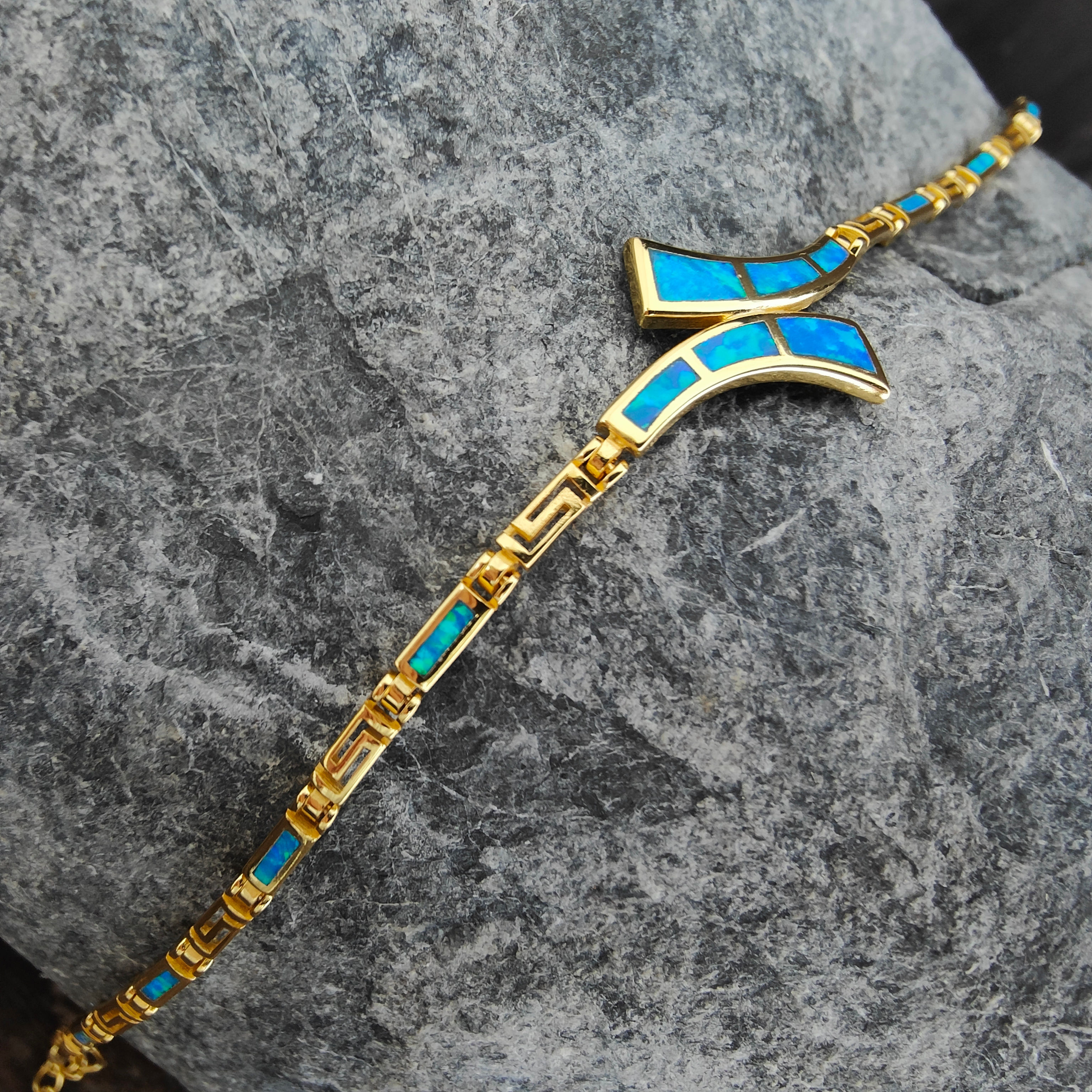 Gold bracelet with turquoise, Olive Leaf Necklace 925 Silver Gold Plated on stone background.