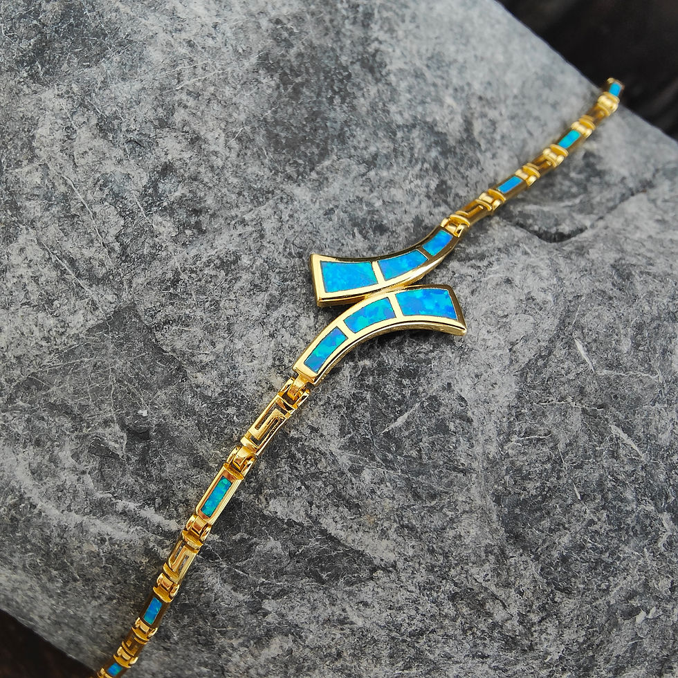 Μικρογραφία: Gold necklace with blue stones on gray rock. Thetistreasures.