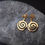 Thumbnail: Golden spiral earrings displayed on a textured gray stone, Thetistreasures