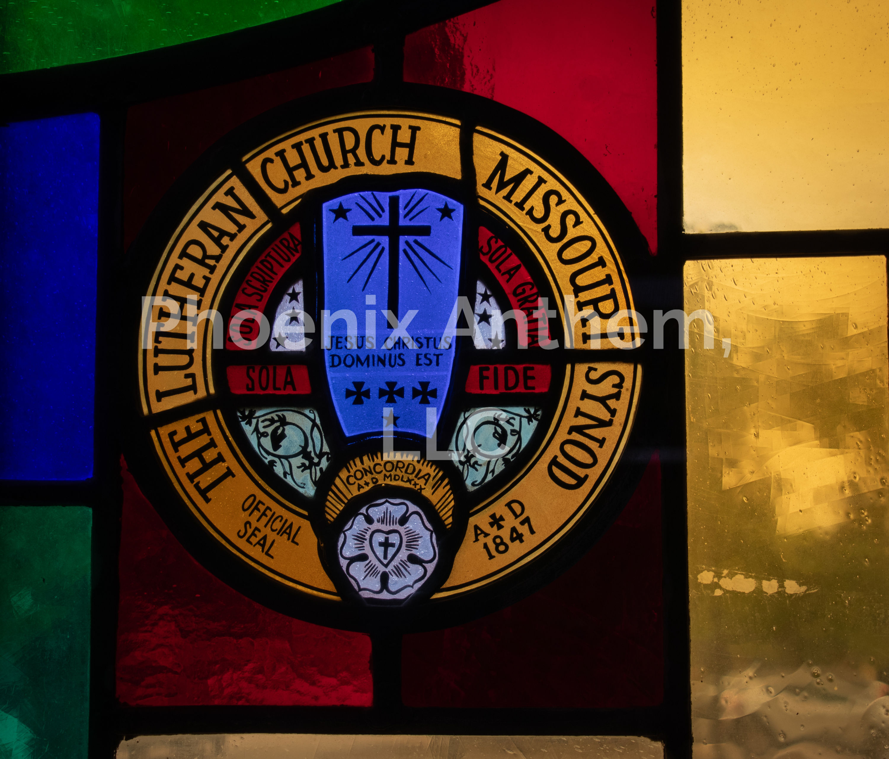 “Stained glass-style image of the LCMS seal with Christ at the center, symbolizing faith in Christ alone & confessional unity