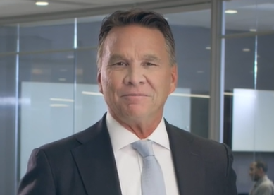 Professional man in suit and tie smiling in office setting