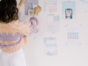 Woman placing photo on wall for mood board