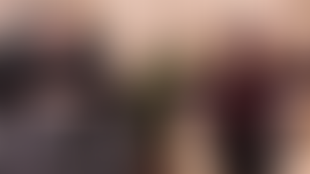 George and Linda Pransky sitting in front of a group with a cat.