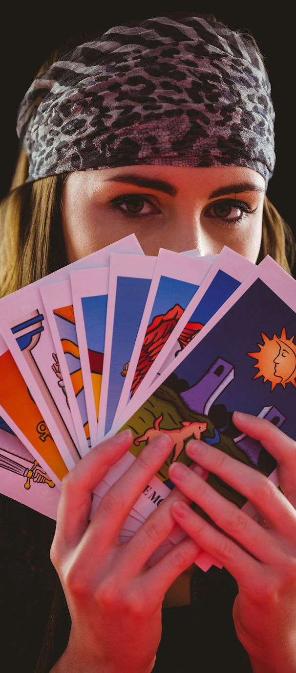 Fortune teller using tarot cards on black background.jpg