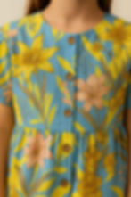 Close-up of floral printed pants with elasticated hem and waistband in bright yellow and blue tones