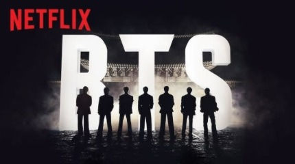 A Netflix é mestre em capitalizar o chamado "Efeito BTS". A plataforma de streaming compreendeu que o sucesso do grupo não é um evento isolado, mas a porta de entrada para um ecossistema cultural lucrativo.