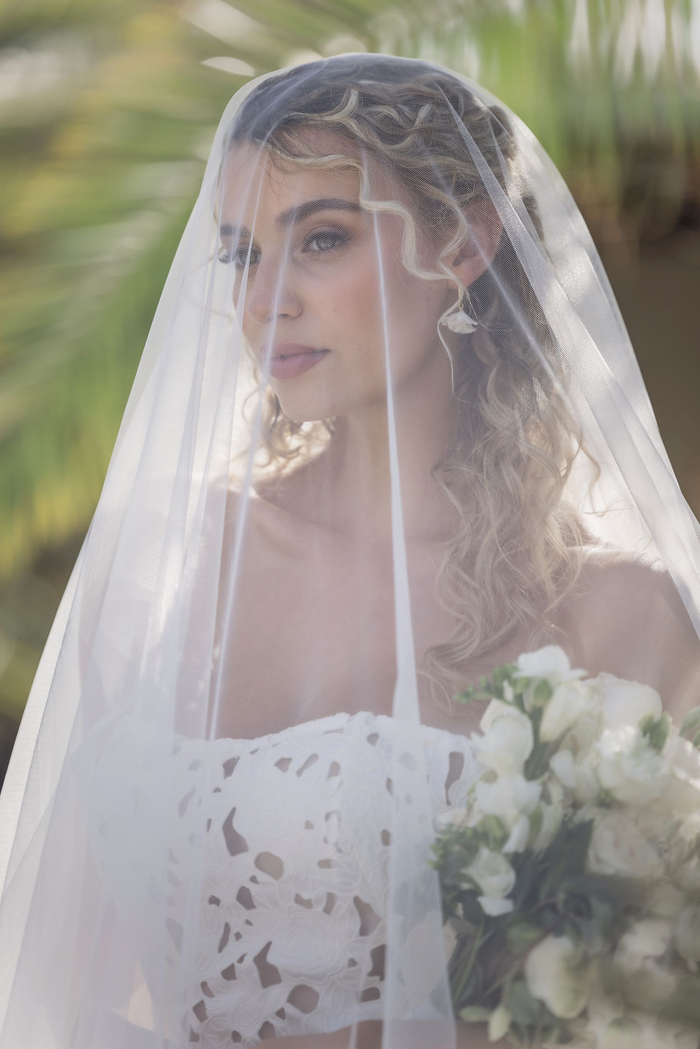 Thumbnail: Bridal floral earrings worn by bride