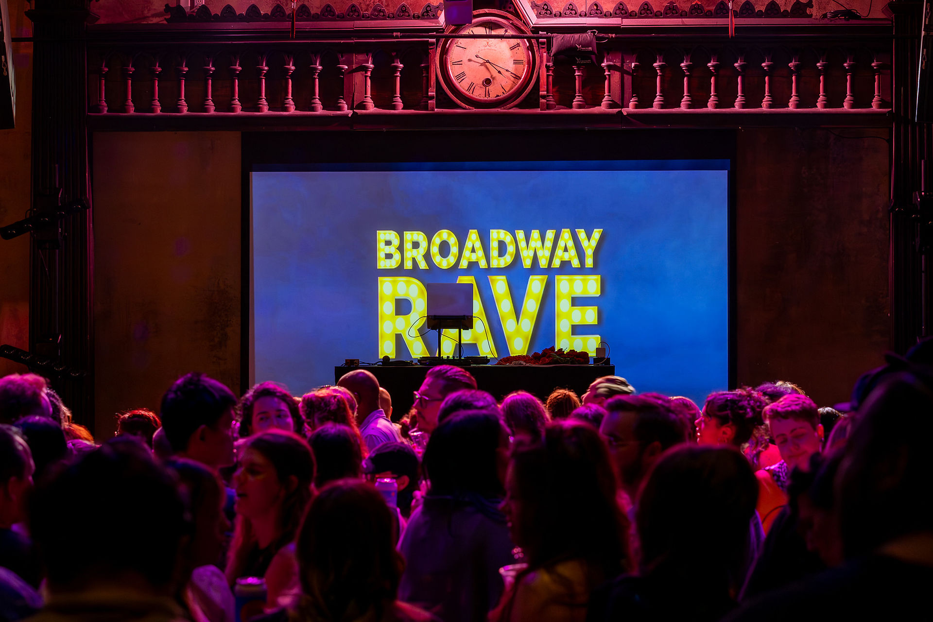Projector screen displaying the words "Broadway Rave"