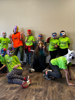 Kids wearing their self-decorated masks in the Acting Workshop.