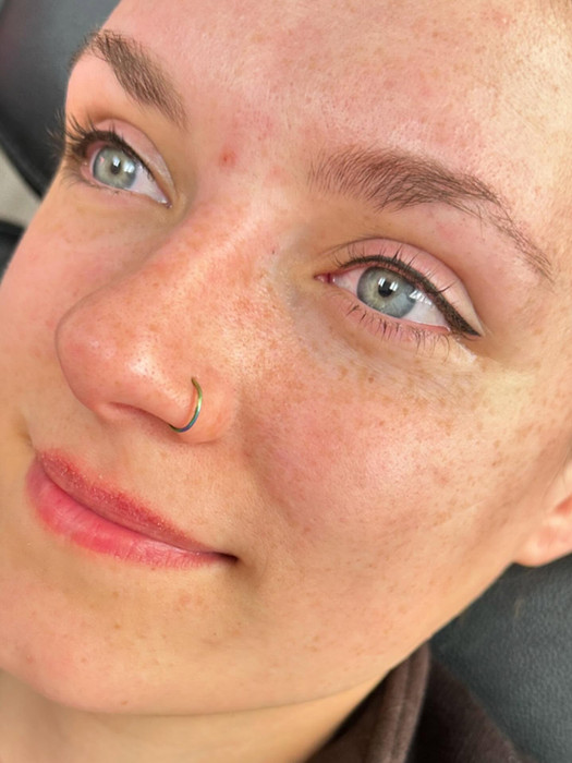 Close-up of permanent makeup eyeliner on a client’s upper lash line.