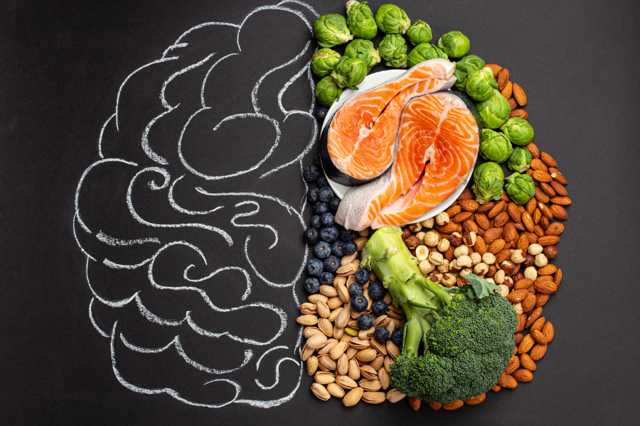 A Chalk board drawing of half of a brain, and the other half is made of health foods