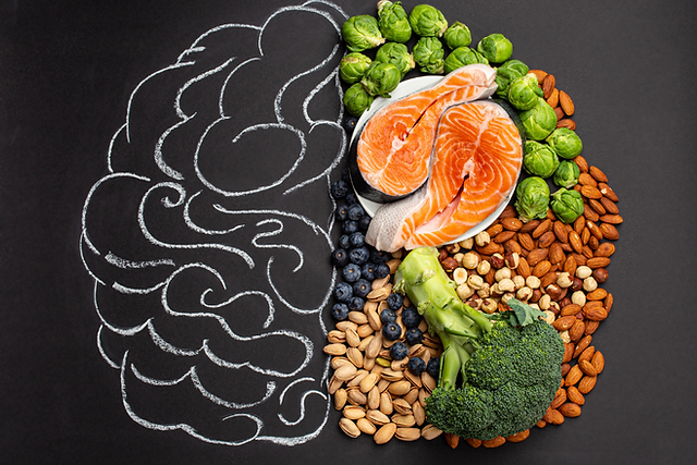 A Chalk board drawing of half of a brain, and the other half is made of health foods
