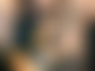 Musician playing guitar and singing into  microphone.