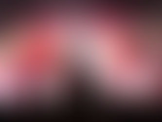 Guitarist on stage plays to a lively crowd. Red and yellow spotlights create a vibrant atmosphere. Silhouettes and raised hands visible.