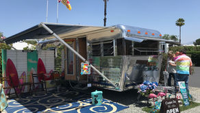 Eye-level view of a classic silver vintage trailer parked at a trailer show, 2018