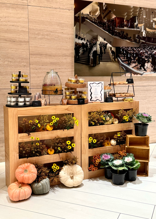 Fall themed workshop station with pumpkins and flowers.