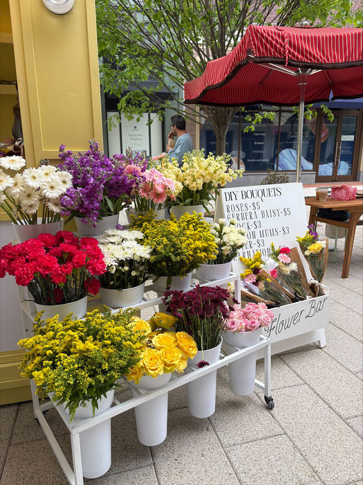 Outdoor flower market stall with colorful bouquets.