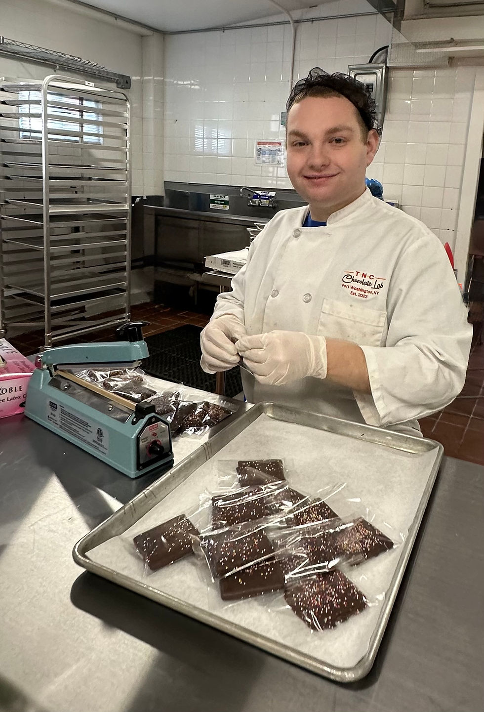 someone in a chef coat working with chocolate