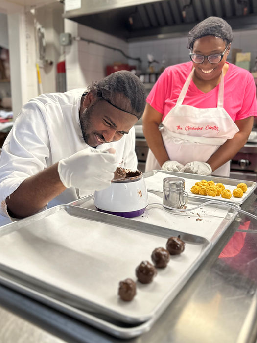 two people smiling and working