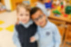 2 young students hugging