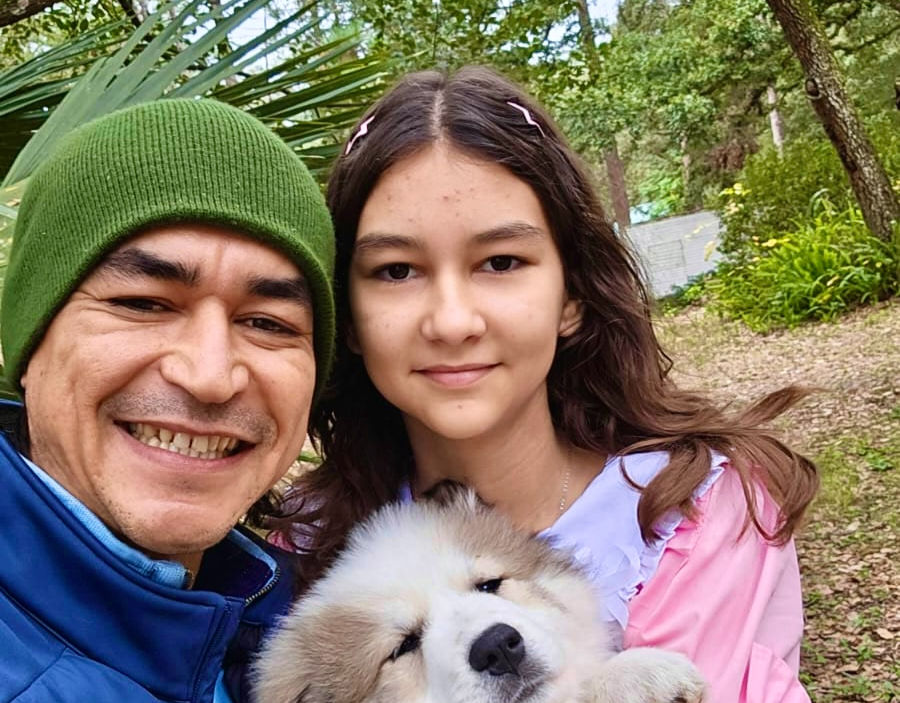 Sanjar and his daughter and their puppy.