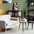 Empty chair and sofa iin front of small table in office of psychologist.jpg
