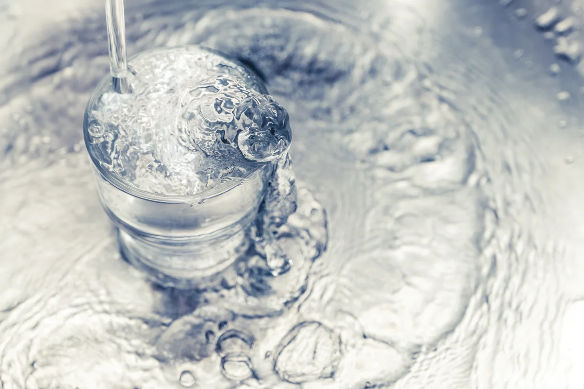Water overflowing out of a cup