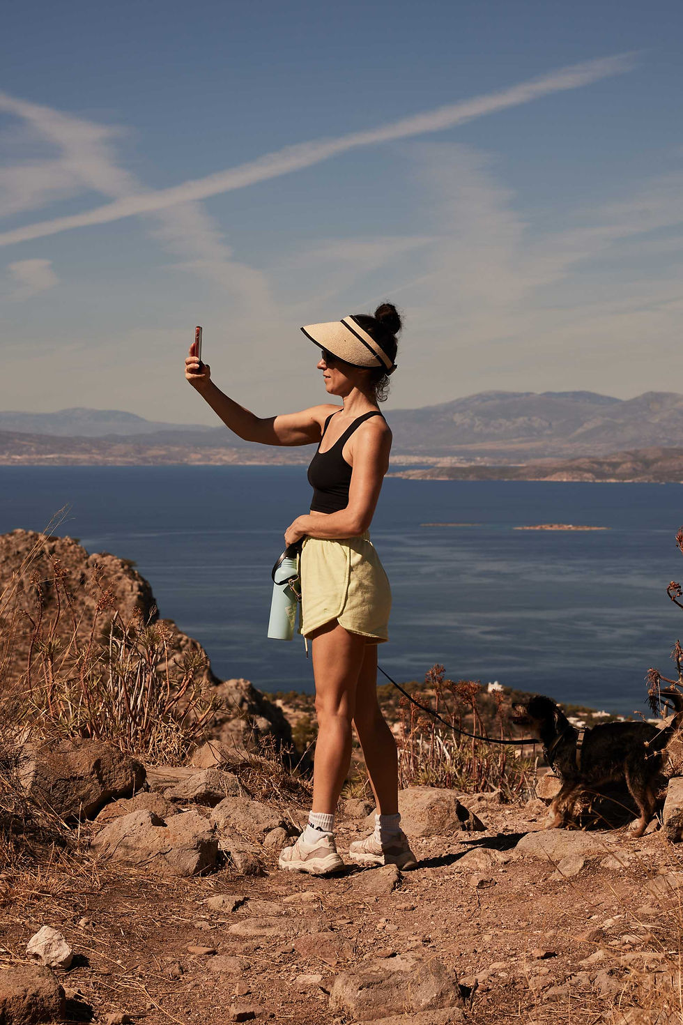 Girl taking a joyful selfie during a scenic hike at an Evexia Retreat.