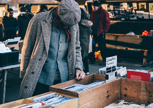 Person-browsing-in-bric-a-brac-sale.jpeg