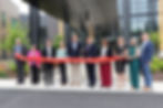 People gather to cut the ribbon on The Lodge at Autumn Willow