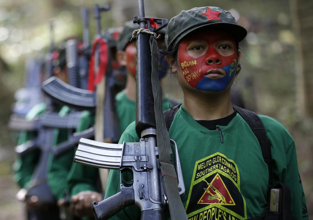 Members of the New People's Army communist rebels with face painted to conceal their identities southeast of Manila in 2016.