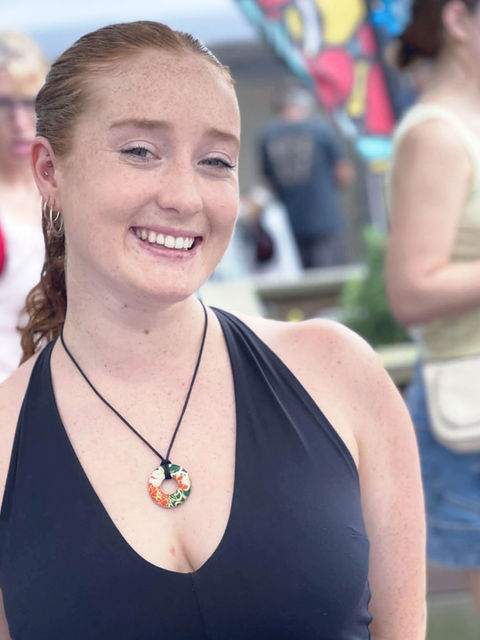 girl wearing round washer pendant in red and black made with Japanese papers