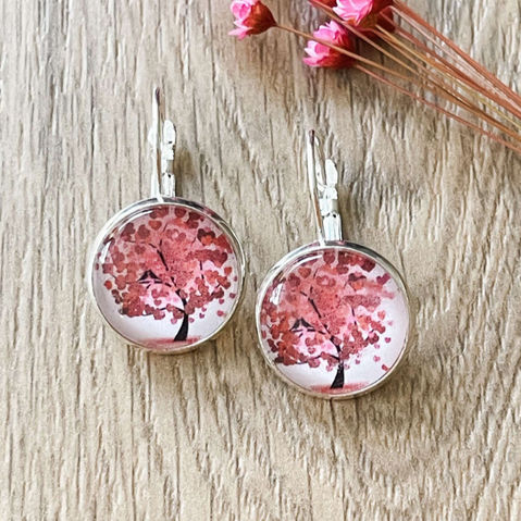 Round earrings with pink tree of life image on glass in a silver tray earring.