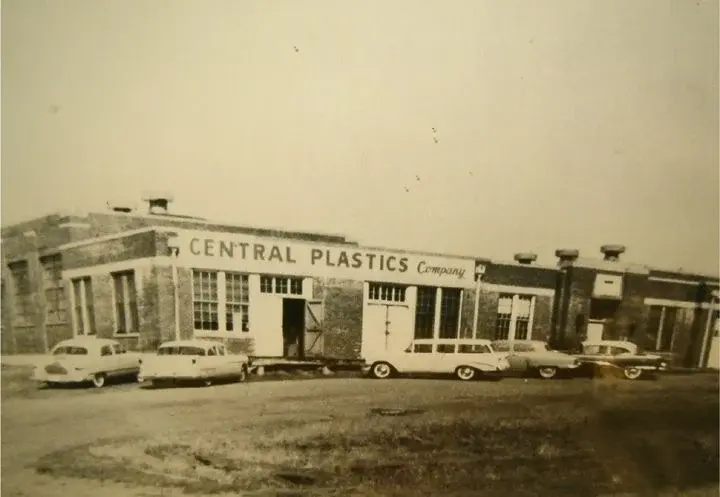Central Plastics Company image from the mid-1900s. It shows old cars in front of a small warehouse.