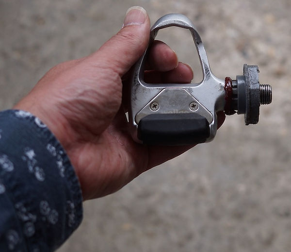 hand holding reassembled bicycle spd pedal