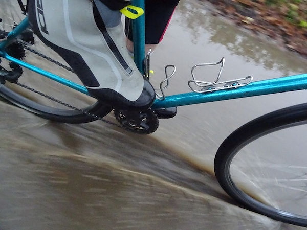bicycle going though big deep puddle
