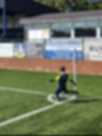 Young player taking a corner kick on a soccer field.