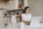 Woman in glasses hyperfocusing on doing something on her laptop
