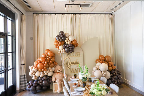 Neutral Balloons and backdrop panels for a teddy bear themed baby shower