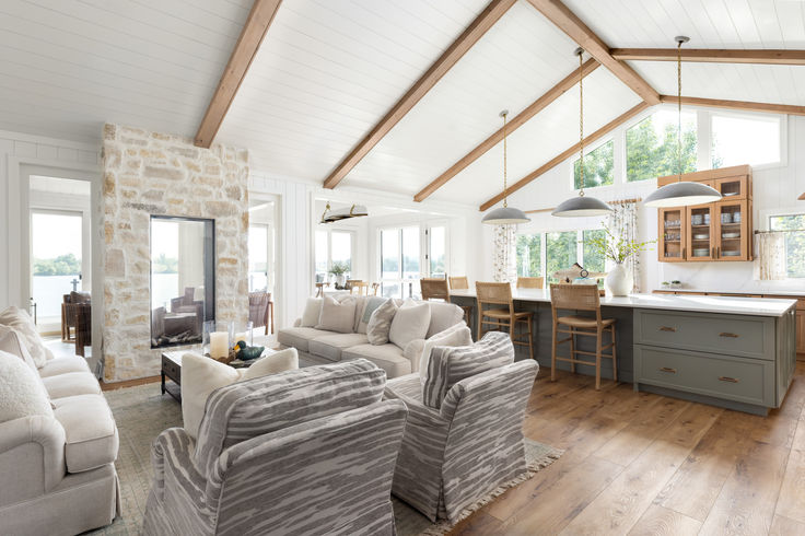 Lake home great room with furniture, wood beams, and shiplap walls and ceiling by Laura Lien Interior Design